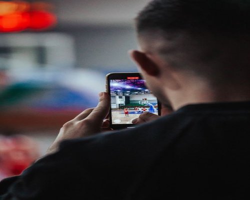 Smartphone showing a fictional CROWN mobile arena game